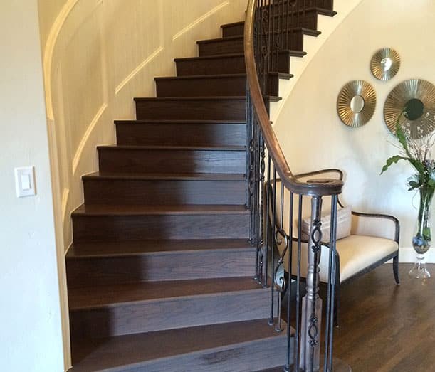 Finished staircase remodel in Plano TX showcasing completed wood treads and secure railing installation